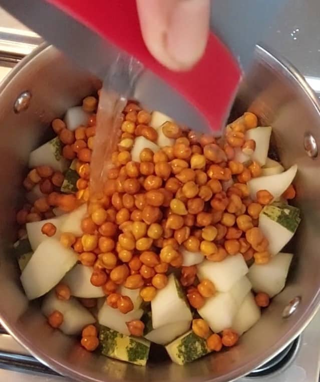 Drain off water from the chana and transfer it to the same vessel. Add 2 cups of water and mix once. Add salt, close the lid and cook well.
