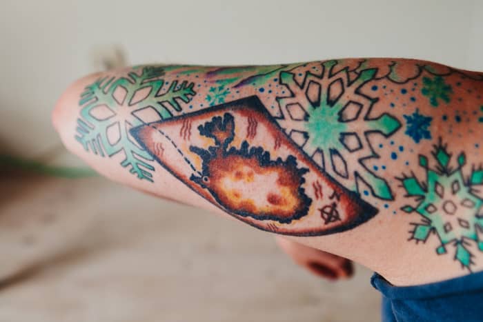 Snowflakes pair extremely well with other tattoos, especially stars, trees, bird, fairies, butterflies, or in this case a map.