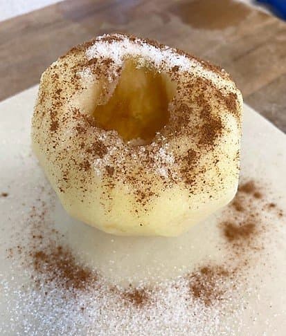 Place the apple in the middle of the dough square and sprinkle sugar and cinnamon over, filling the hole in the middle almost to the top with the sugar.