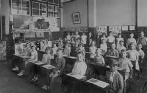 "The students stopped what they were doing and turned their blue-eyes toward the front of the class. There, they saw their teacher standing near the tanned boy with brown eyes and hair."