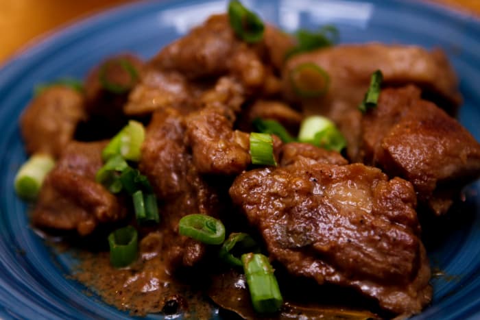 This is a recipe for Filipino Pork Adobo. It's a dish made with pork slices cooked in soy sauce, vinegar, and garlic. Onions are included in some versions. Adobo, like Sinigang, is a popular Filipino dish. This is a recipe for Filipino Pork Adobo.