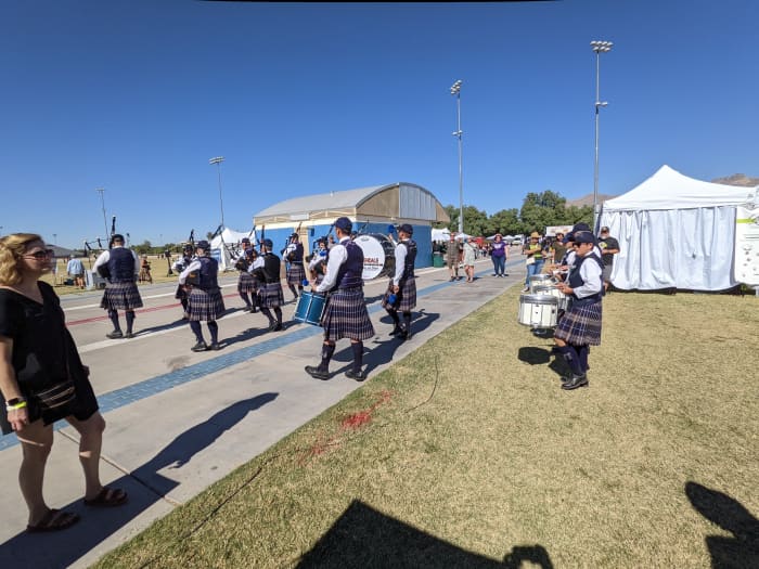 Marchers in full Scotts regalia marching with drums and bag pipes.