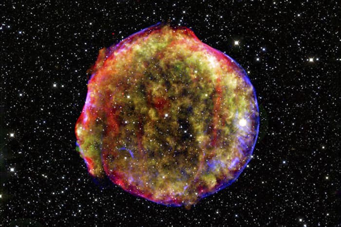The image of Tycho’s supernova of 1572 is a composite of an X-ray image taken by the orbiting Chandra X-ray Observatory, an infrared image taken by the orbiting Spitzer Space Telescope, and an optical telescope.