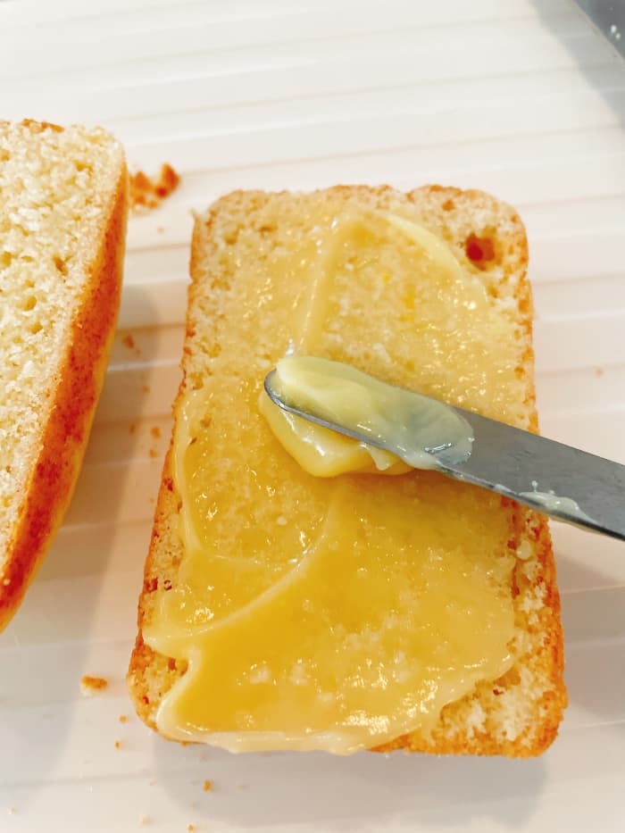 Use an icing spatula to spread the lemon curd on each loaf. Then place reassemble the loaf like a sandwich.