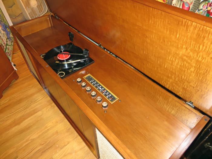 See how the Wood Reflects the light on this Curtis Mathes Stereo Model # 40M653 was made 09-18-1961. It has almost a jewel like quality. The right piece had to be selected for the top and each side.