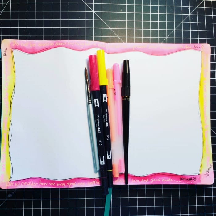 This page from my bullet journal was created with a watercolor paintbrush, red and yellow Tombow watercolor markers, orange and pink Gelly Roll pens, and the black carbon pen.