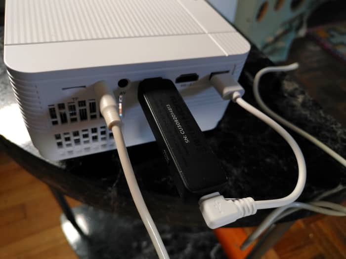View of audio cable carrying the signal from a projector to the Tribit portable speaker