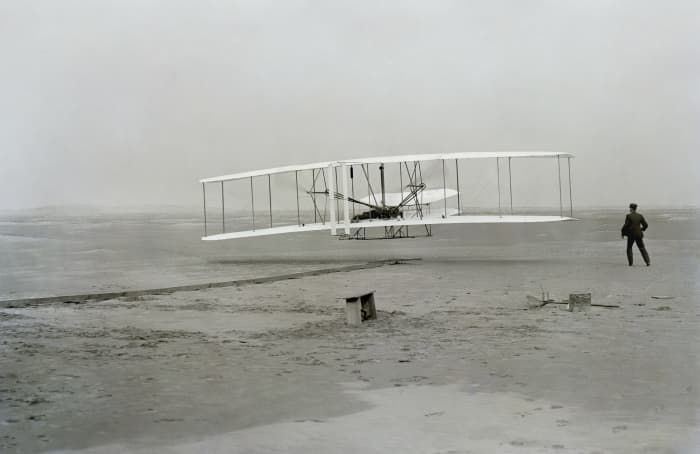 The first controlled, sustained flight of a powered, heavier-than-air aircraft with the Wright Flyer. December 17, 1903