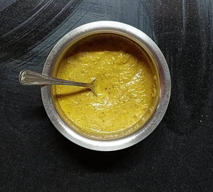 Transfer this mixture to a mixer jar. Add 1 cup coriander leaves, salt to taste and 1/2 cup water. Cose the lid and grind to a fine paste. Onion tomato chutney is ready. Transfer to a vessel. Add water if required for the desired consistency.
