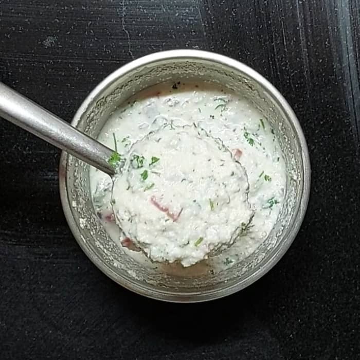 After soaking, the rava will have absorbed the water and thickened the batter. Add little water if you feel the batter is too thick.