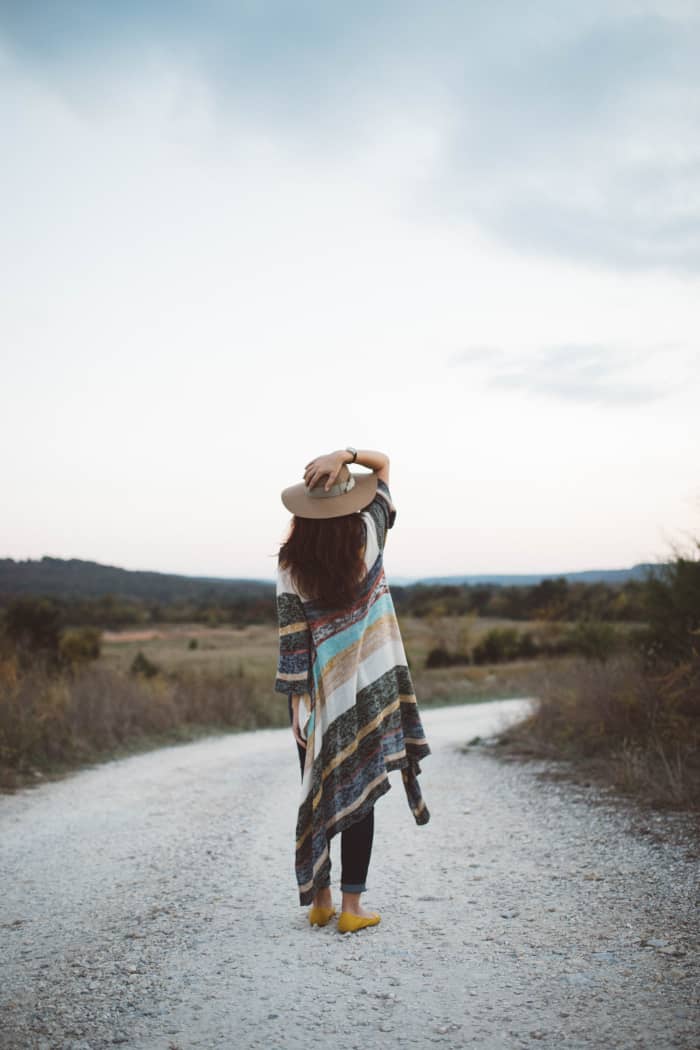 Capricorn embraces colors you would commonly see in winter: charcoal gray, coffee brown, whitish-gray, and tan. The poncho this woman is wearing has a mostly yin-vibe to it. I can see a Capricorn friend wearing this.