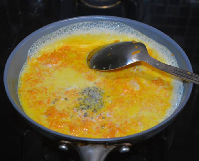 Step five: Add boiled milk, sugar (or jaggery), and powdered cardamom. I used jaggery in this recipe because it is a healthier option. Mix well and bring it to a boil.