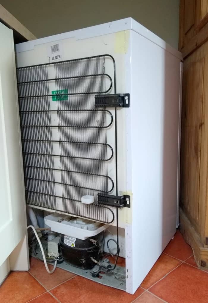 Condenser at the back of a refrigerator. Heat from inside the fridge is removed from the circulating refrigerant by ambient air.