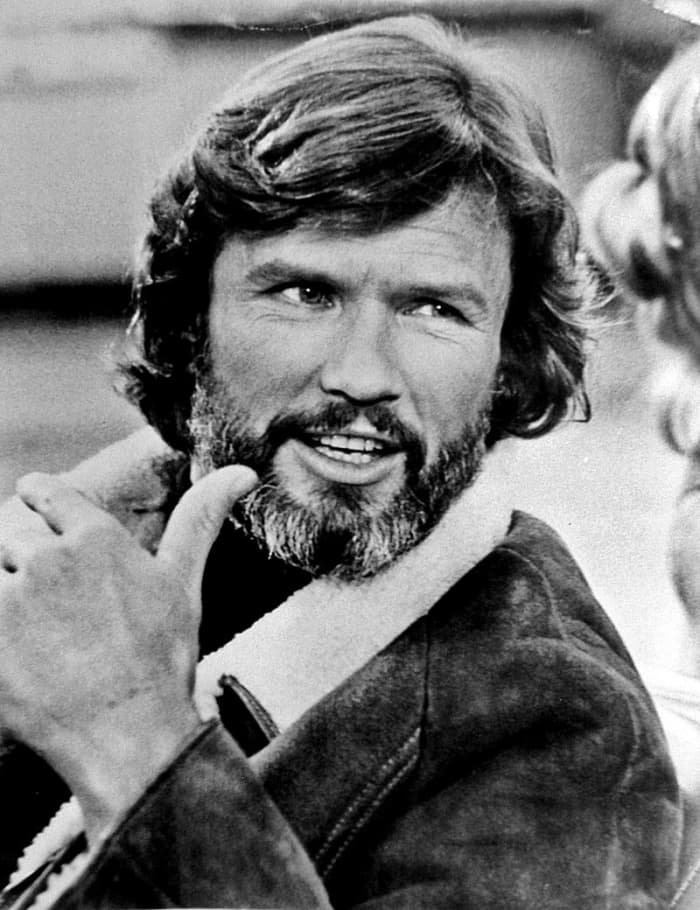 Talent agency publicity photo of Kris Kristofferson, 1977. Kristofferson and Barbara Streisand appeared in yet another version of A Star is Born attempting to show the stress of life on musicians and the use of alcohol as a panacea for that stress.