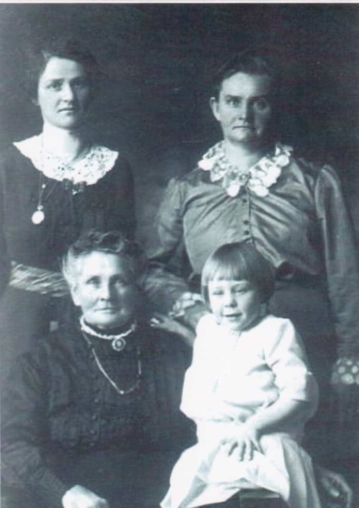 Standing from left to right: second cousin Emma and great-aunt Teckla. Sitting are great-grandma Bertha Kuehn and Emma's daughter