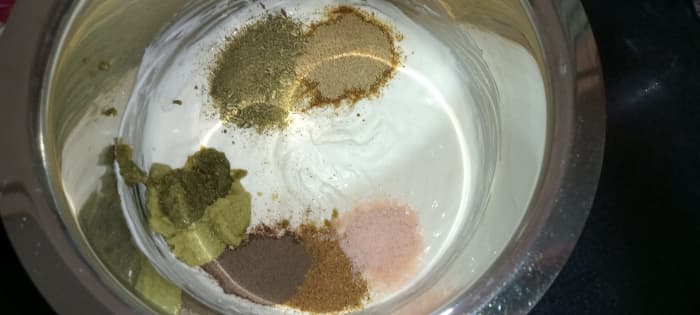 Add ginger-garlic paste, green chilli paste, dried fenugreek leaves powder, garam masala powder, black pepper powder, chaat masala, and salt.