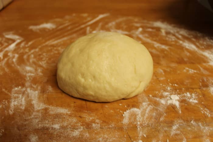 Transfer the dough to a flat surface dusted with flour. Knead the dough until it is soft and pliable.