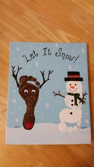 Snowman and reindeer feet on a canvas. Such a fun winter holiday craft for your preschooler or toddler. Fun activity for daycare, too!