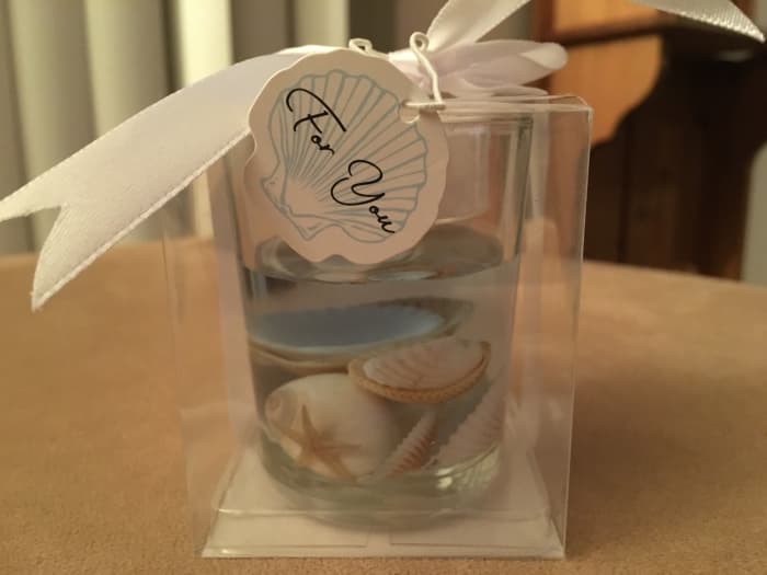 A small candle holder with shells secured in gel and a tea candle on top made a very nice party favor. No, I didn't make the party favors!