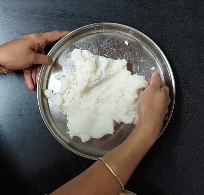 Transfer the mixture to a plate. Let it sit for 5-7 minutes or till it cools down slightly. When the mixture is cool enough to knead with your hands, start kneading the dough.