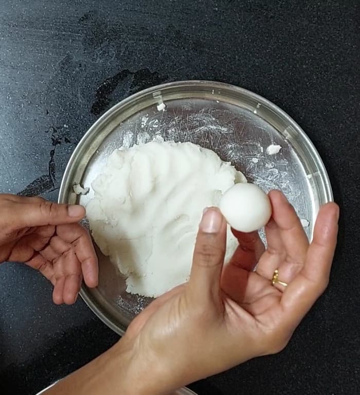 Pinch a small portion of the dough and make a small ball. Repeat the same procedure and make balls with the remaining dough.