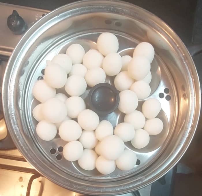 Boil enough water in idli cooker or steamer, keep the idli stand or plate to steam, close the lid and steam-cook for 15 minutes over medium flame.