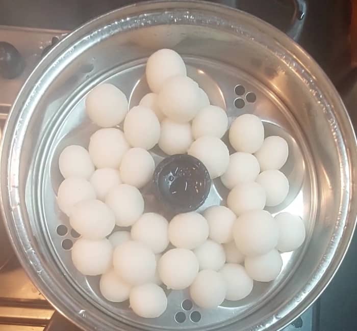After 15 minutes, open the lid and check if the balls are steamed properly. If balls are not sticky then they are done. Switch off the flame.