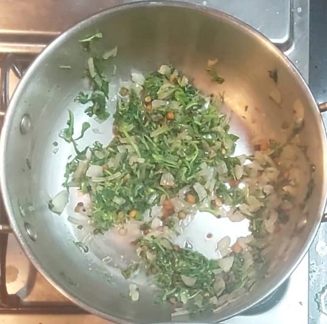 Add 1 cup chopped methi (fenugreek) leaves and salt. Fry till leaves shrink. Close the lid and cook over low flame for 2 minutes.