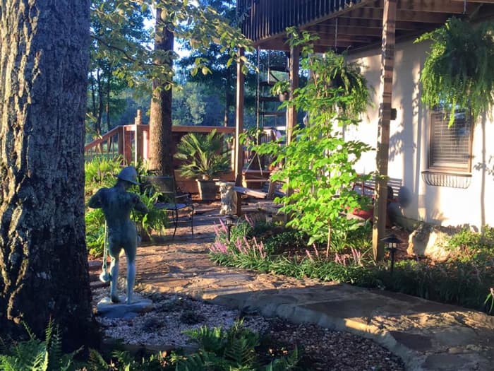 What started as two large trees, is now a Zen Garden boasting ten different species of ferns, ten different species of hostas, two varieties of japonica, caladiums, and several varieties of azaleas.