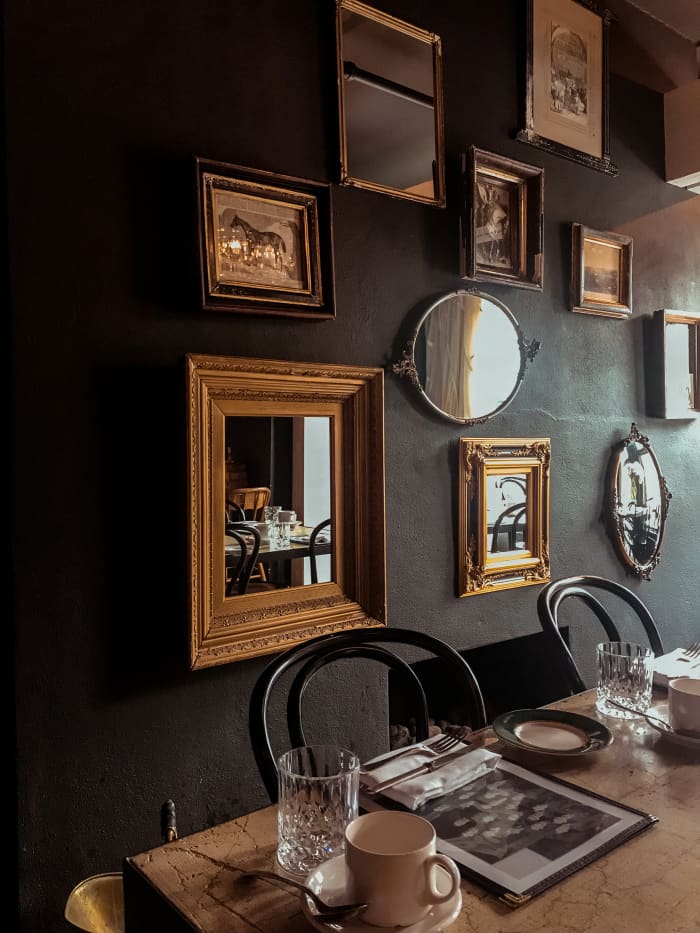 Sagittarius homes should be lively. There should be a mix of patterns and objects to give rooms dimension. For instance, this room has an array of art, but the dark color of the walls helps the room to look serious and mature.