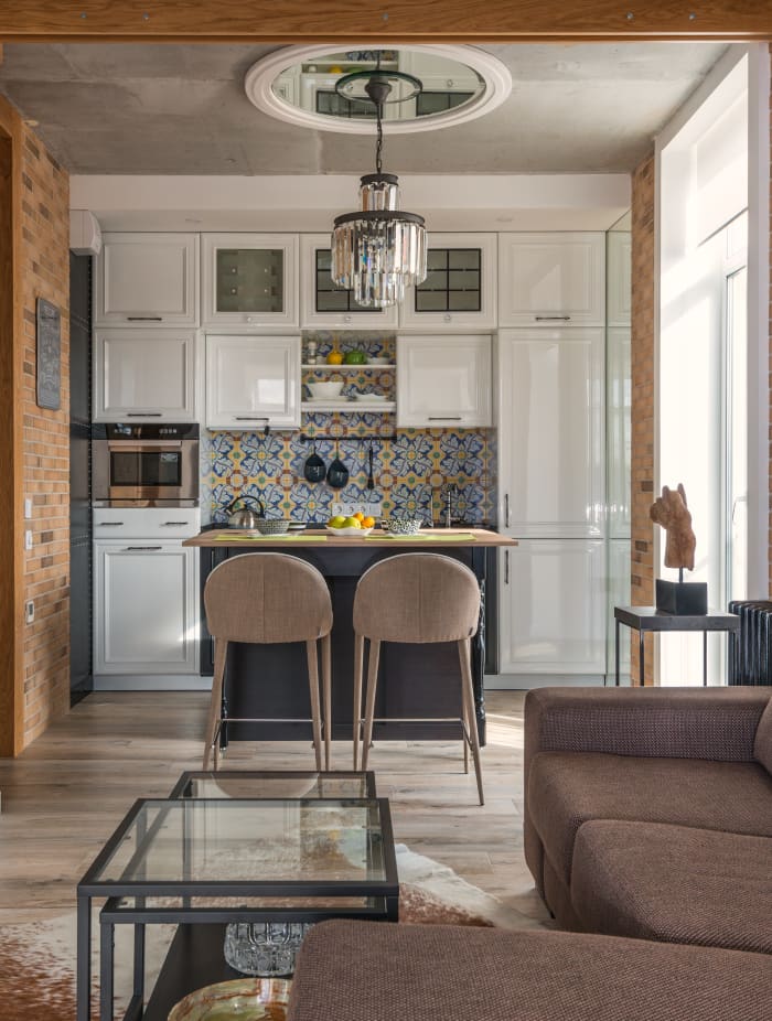 This kitchen does a beautiful job of mixing patterns and making it all cohesive. The final result is a kitchen and living area that's refined.