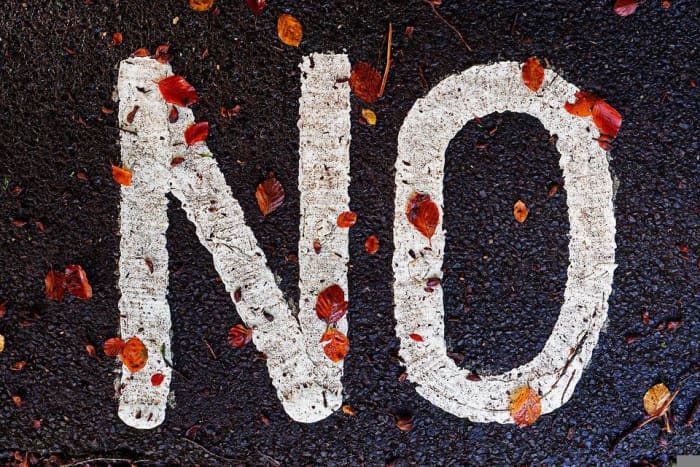 When turning down a job promotion, you have to be direct and state you are turning it down. Don't be vague!