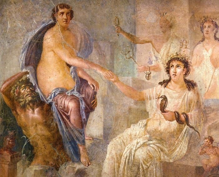 Io (on the left, with horns) is welcomed in Egypt by Isis (sitting, holding a snake and with a crocodile at her feet).
