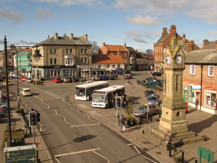 Thirsk Market Place again, this direction looks back to where the sports car posed where it came in from the right behind the bus stand