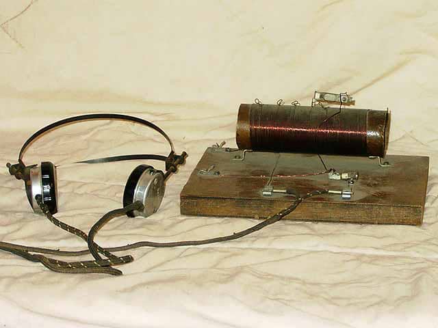 This is a simple crystal radio. It requires no battery or any power source for that matter.