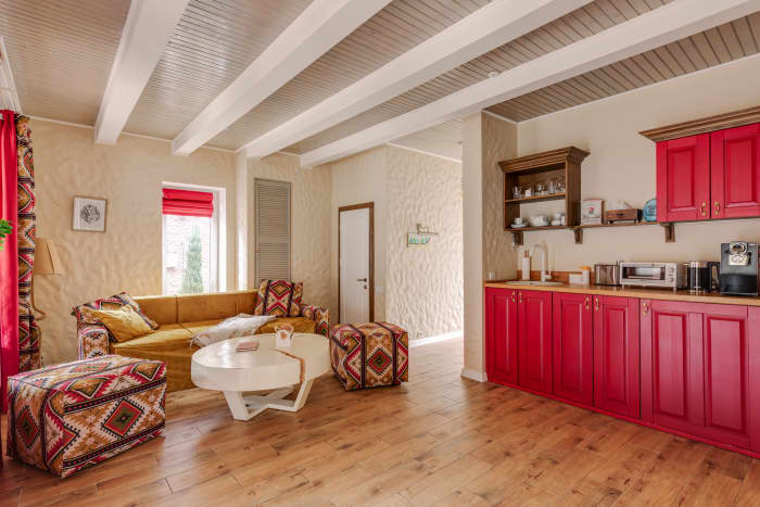 The Ox living room would look nice with wood elements and touches of red. Avoid white and green as much as possible.