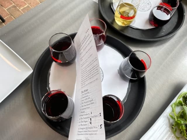 This is one of the wine flights. The glasses are on top of a number and then they have the information for that wine on the piece of paper. Do you see how full those glasses are?!