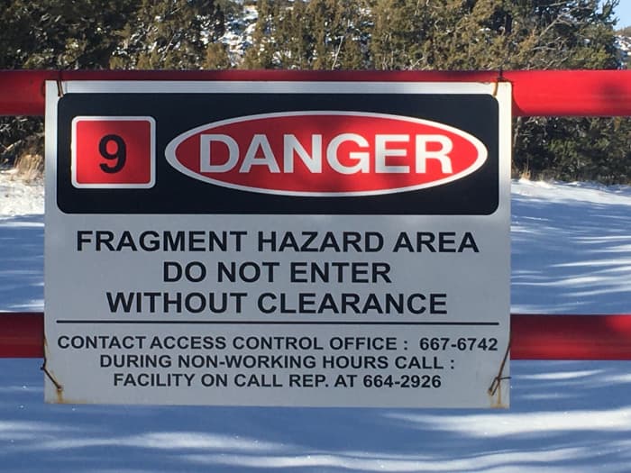 Warning signs at the perimeter fence of the National Laboratories in Los Alamos, New Mexico. You will see numerous signs like these on your way to Bandelier.