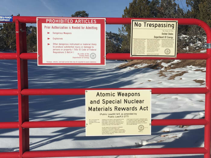 Warning signs at the perimeter fence of the National Laboratories in Los Alamos, New Mexico. You will see numerous signs like these on your way to Bandelier.