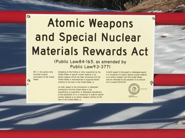 Warning signs (atomic weapons and nuclear materials) at the perimeter fence of the National Laboratories in Los Alamos, New Mexico. You will see numerous signs like these on your way to Bandelier.