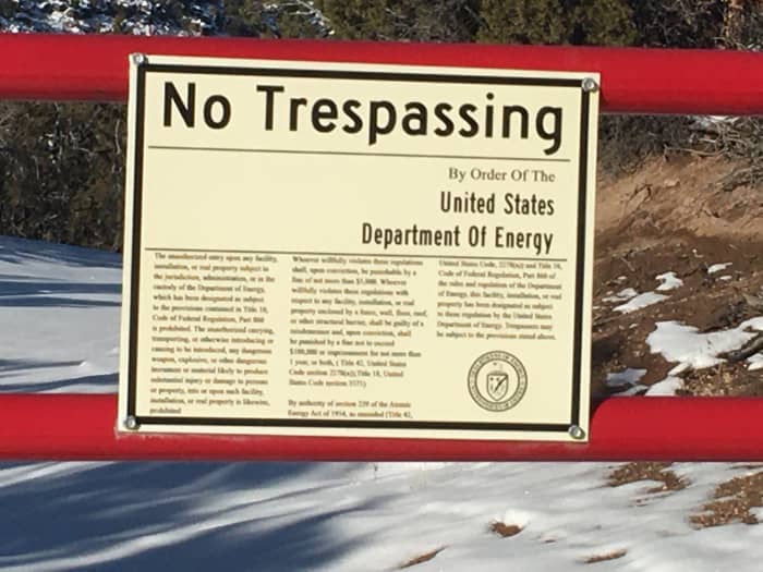 Warning signs at the perimeter fence of the National Laboratories in Los Alamos, New Mexico. You will see numerous signs like these on your way to Bandelier.
