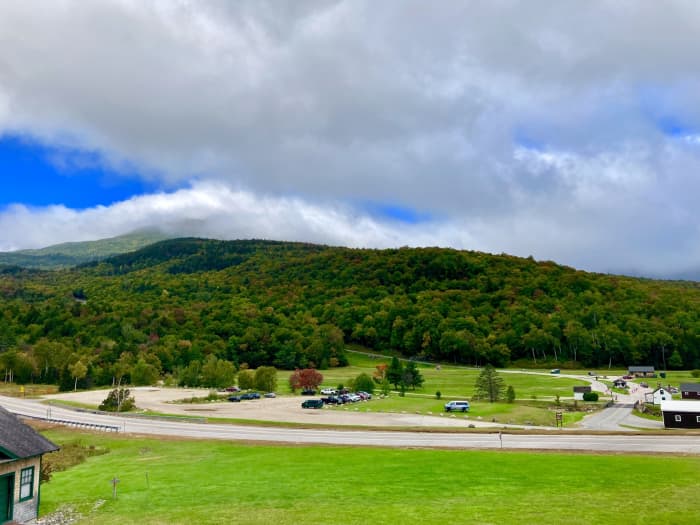View of the start of the Mount Washington Auto Road from the Base Lodge. The summit of Mount Washington is obscured by clouds, but the view is still beautiful.