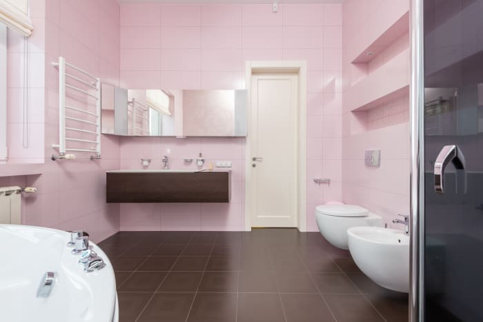 A wide-open bathroom with light pink walls will seem inviting. It will be a refreshing place to take a shower or bath.