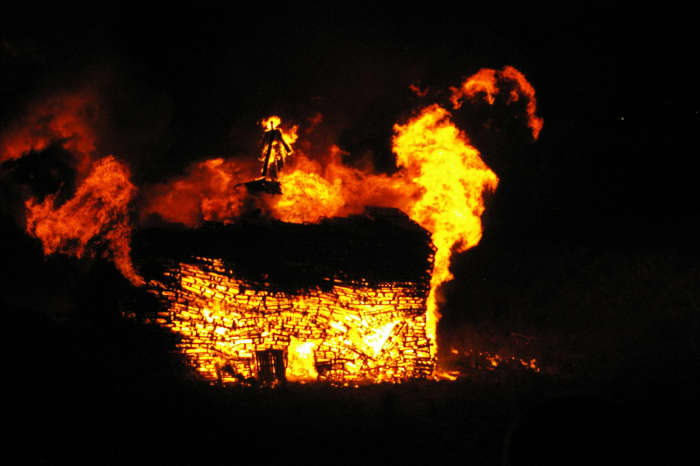 A great bonfire on Guy Fawkes Day with an effigy of the failed Catholic revolutionary Fakes in flames above the blaze.