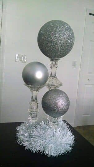 DIY Dollar Tree candlesticks. 2 glued together for medium height, and 3 for the tallest. Place large ornaments on top, or paint Styrofoam spheres