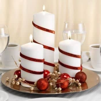 Dollar Store Christmas Crafts/Decorations Gold Charger (Dollar Tree) + Small Round Ornaments (Dollar Tree)+ Gold Berry Bush + Narrow Red Ribbon (Dollar Tree) + Various Sized White Candles Wrap the ribbon to the candle and glue in place.