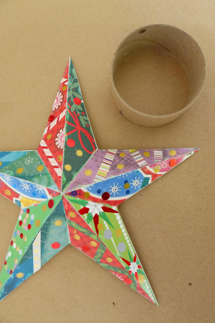 Use hot glue to attach your ring to the back of your star. Your star should then slide down the top of your tree and nestle in the top of your tree.