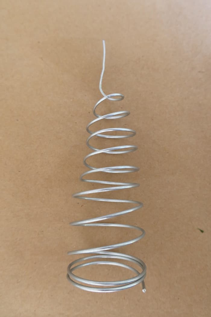 Wrap your wire to make a cone that is long enough to fit securely on the top of your tree