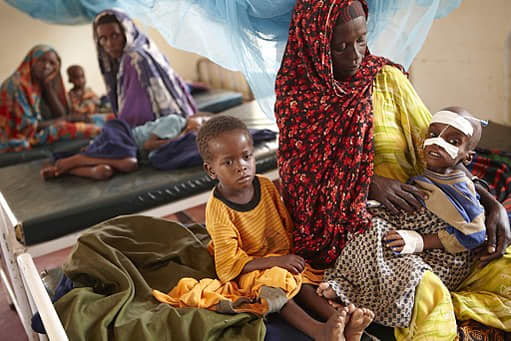 Luli Hassan Ali looks after her severely malnourished four-year-old son, Aden, and his six-year-old brother Mohammed, in a clinic in the Dagahaley camp in Dadaab.