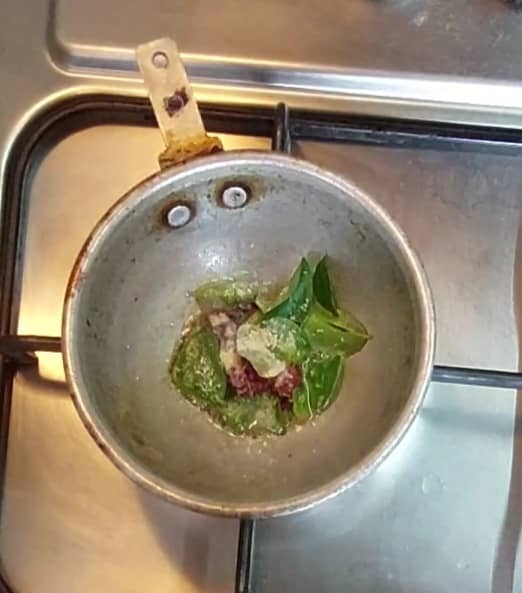 Make the tempering: In a frying pan, heat 1 teaspoon oil and splutter 1/2 teaspoon mustard seeds. Add 1-2 red chilies, a sprig of curry leaves and 1/4 teaspoon hing. Mix well and switch off the flame.
